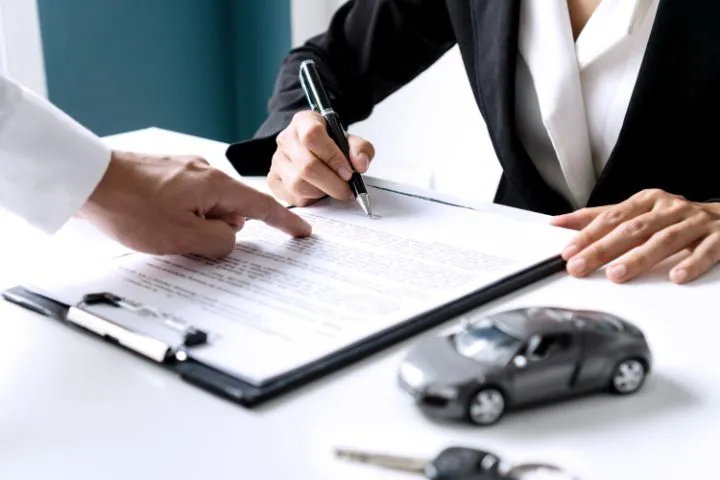 A men is signing a driving license translation document